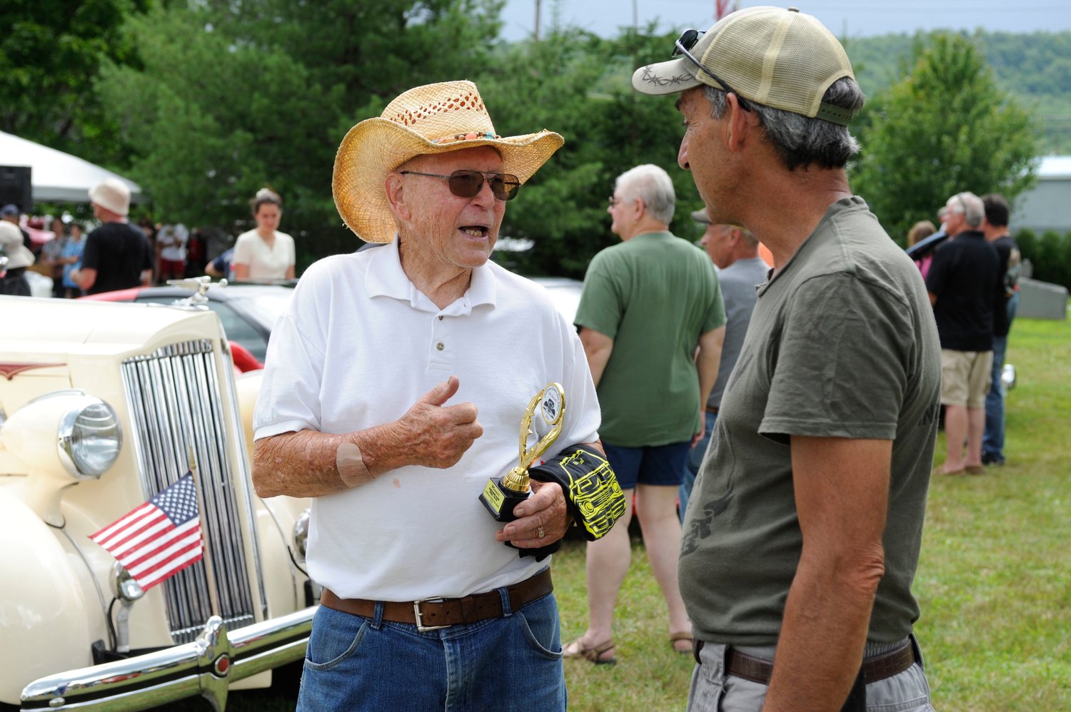 Allan Kehrley talks shop with another vintage car and motorcycle enthusiast moments after receiving an award.